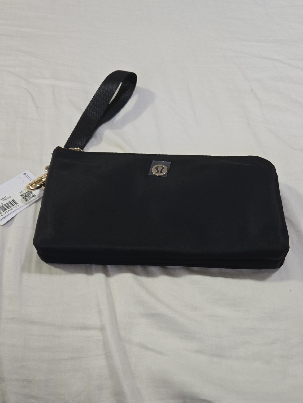 lululemon black clutch with gold logo disc